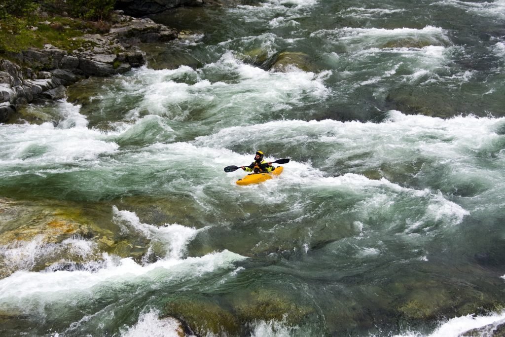 Beautiful scenery of the rafting on the mountain river stream flowing down between huge stones